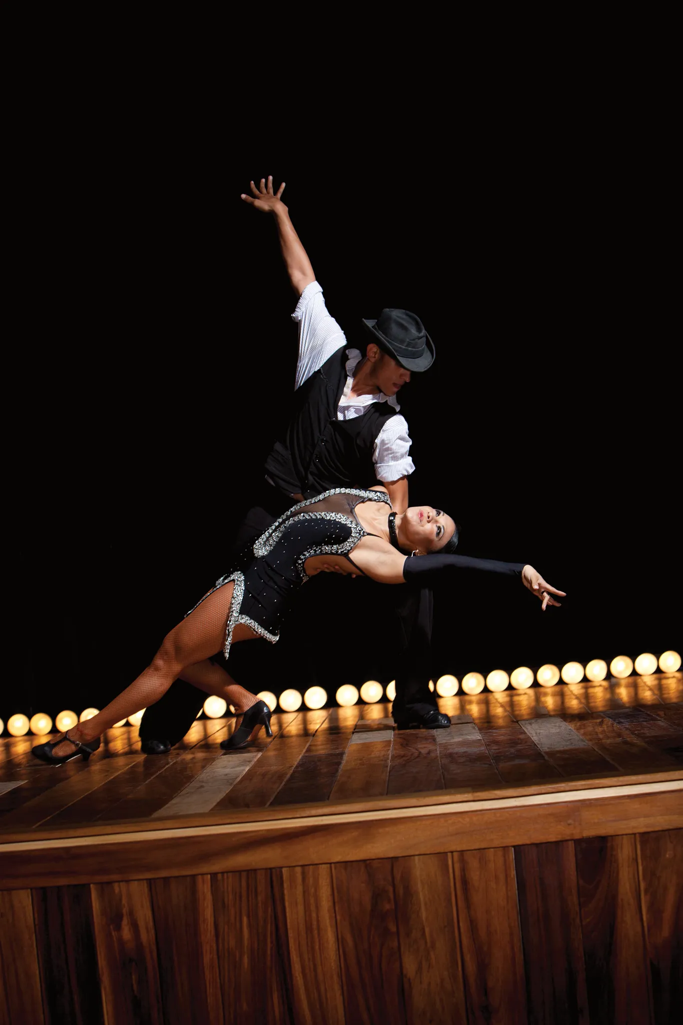 Ballroom dancers performing an elegant routine on stage during evening entertainment at Dreams Vallarta Bay Resort & Spa.