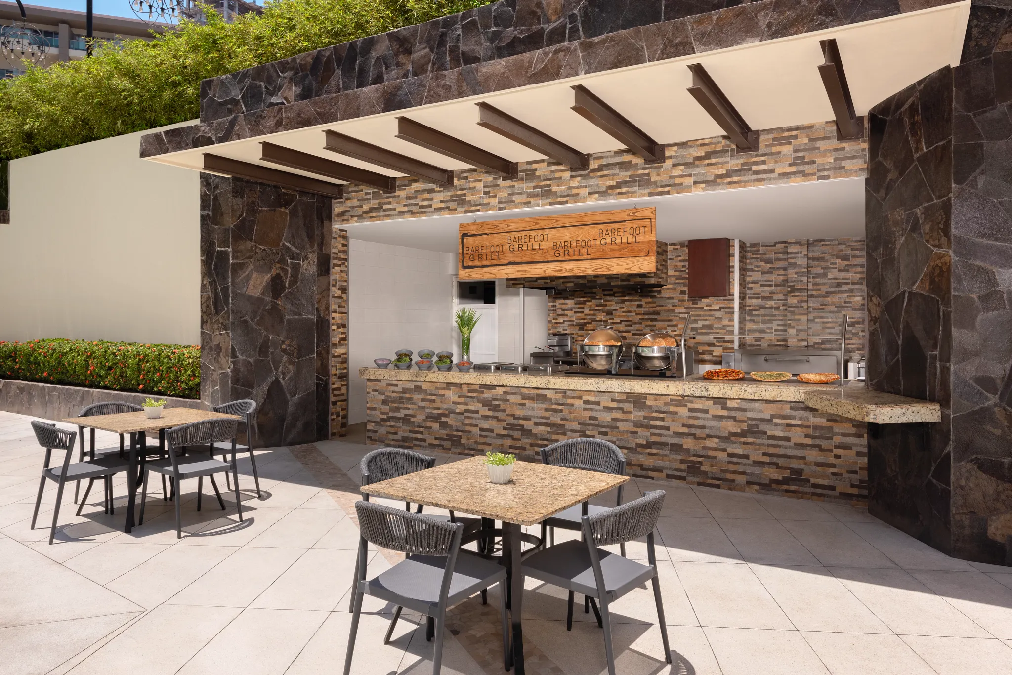 Barefoot Grill at Dreams Vallarta Bay Resort & Spa featuring a casual open-air poolside grill serving lunch with outdoor seating.