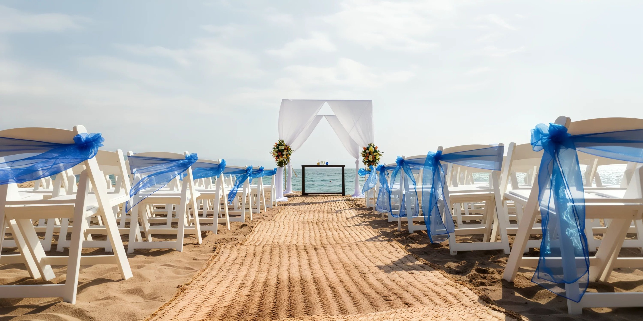 Beach wedding ceremony setup with blue décor at Dreams Vallarta Bay Resort & Spa