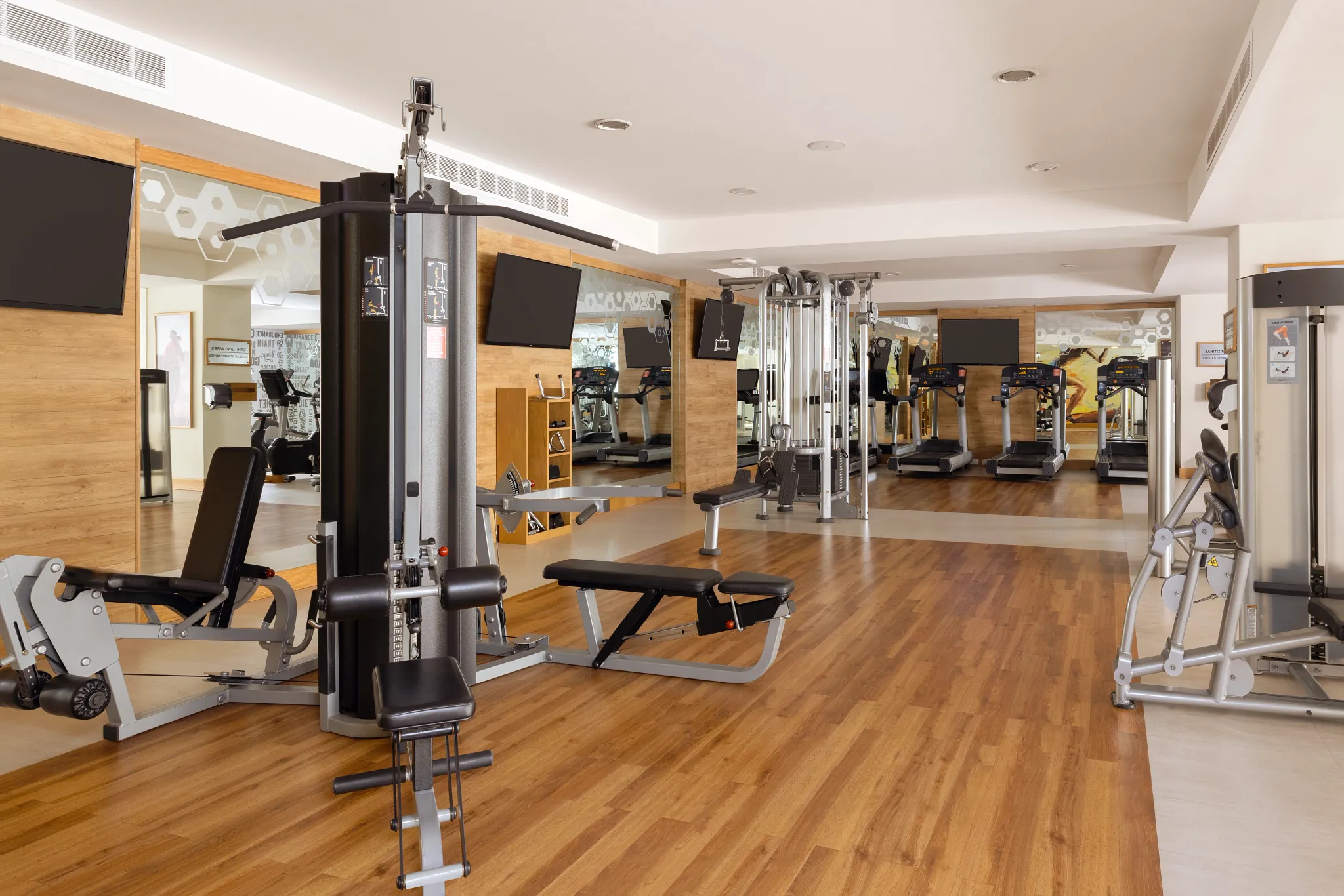 Modern fitness center with treadmills and strength equipment at Dreams Vallarta Bay Resort & Spa.