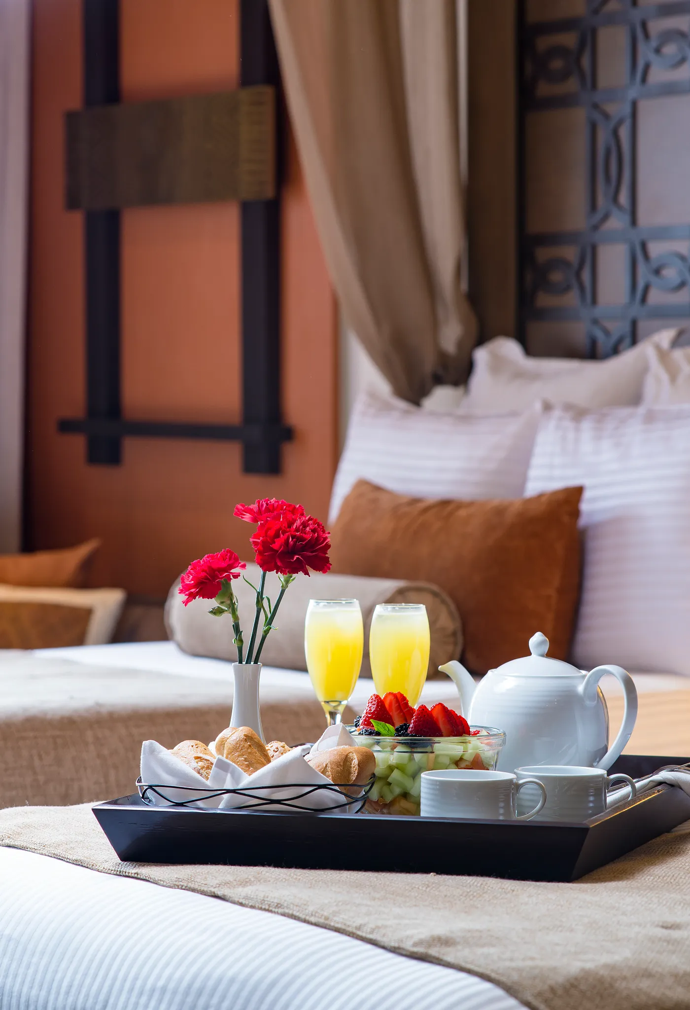 In-room breakfast tray with fresh fruit, pastries, and mimosas served in a luxury suite at Dreams Vallarta Bay Resort & Spa.
