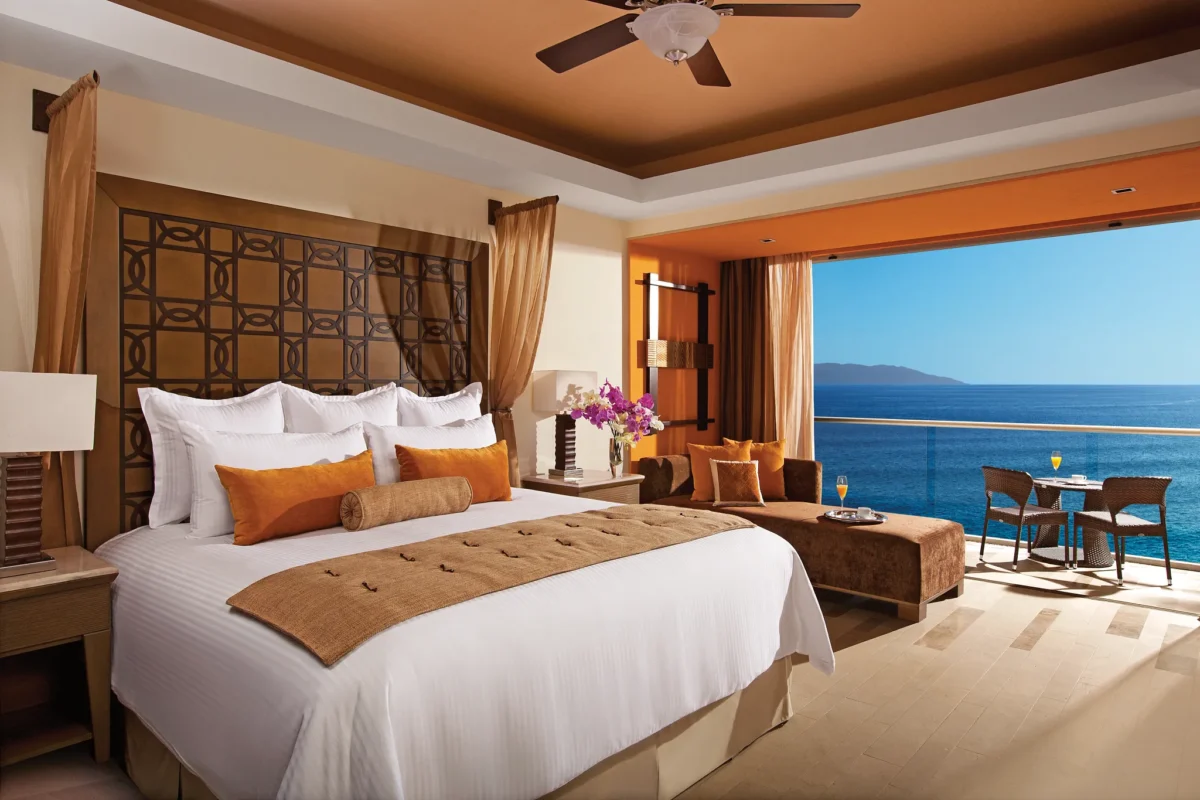 Junior Suite Ocean View with king bed and private balcony overlooking the ocean at Dreams Vallarta Bay Resort & Spa.