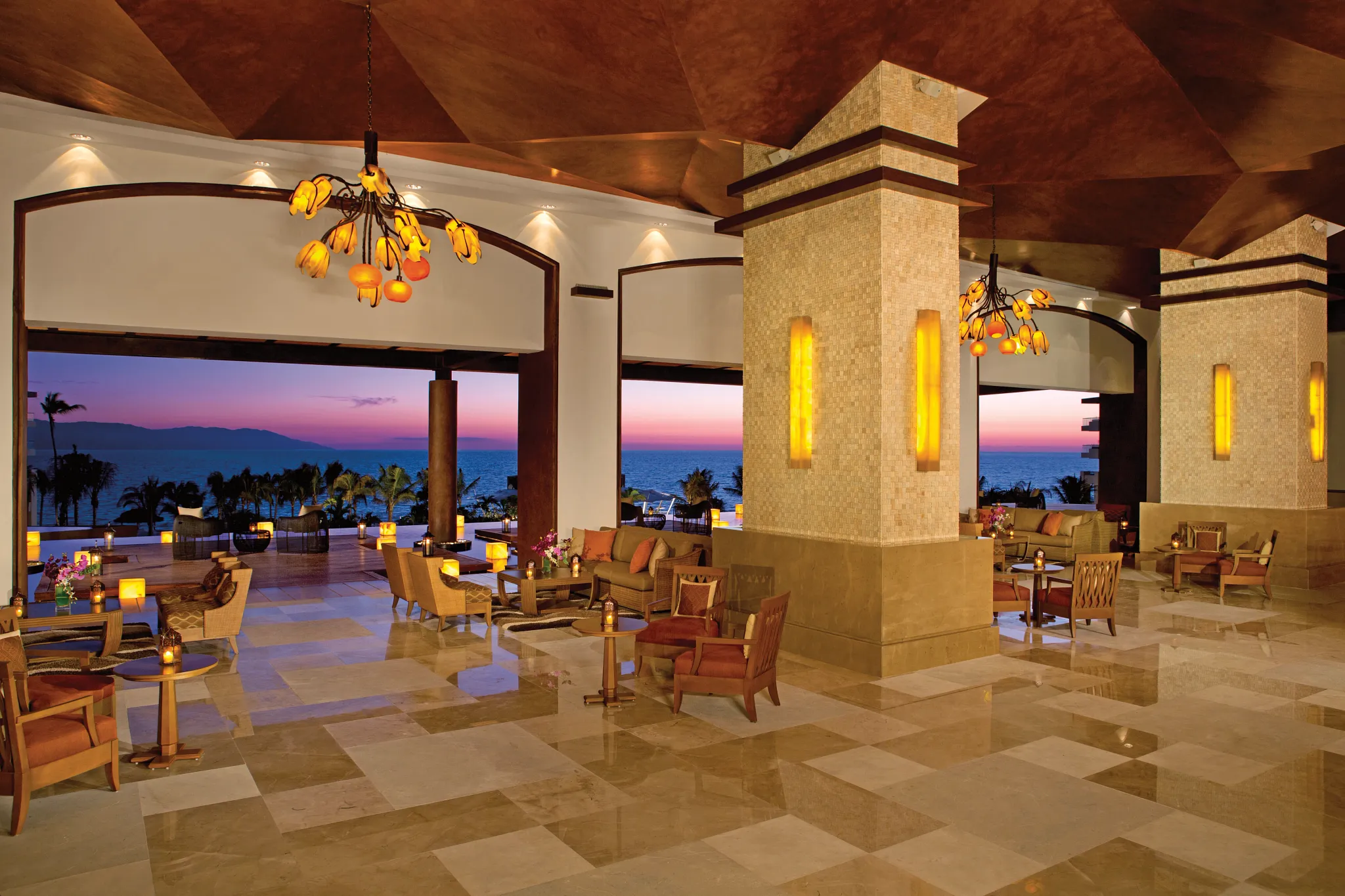 Elegant open-air lobby lounge with ocean views at Dreams Vallarta Bay Resort & Spa.