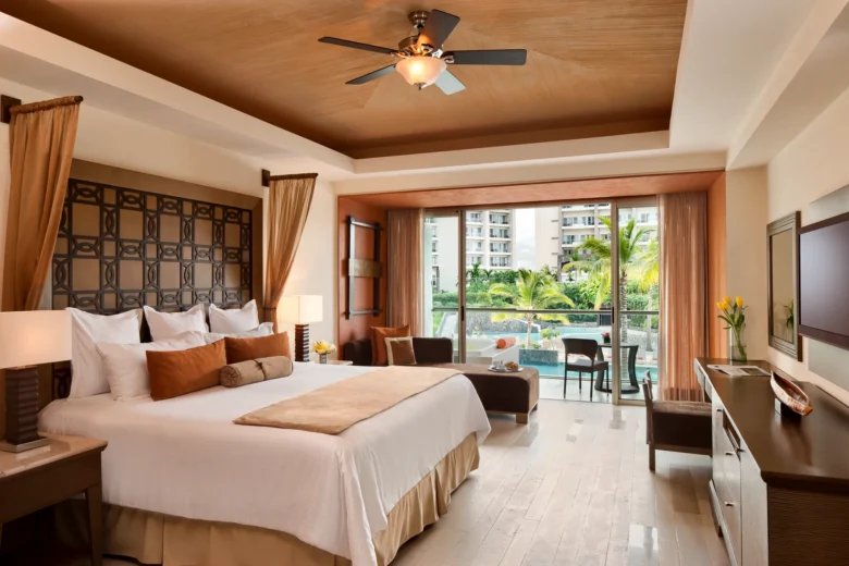 Preferred Club Junior Suite Garden View with king bed and balcony at Dreams Vallarta Bay Resort & Spa.