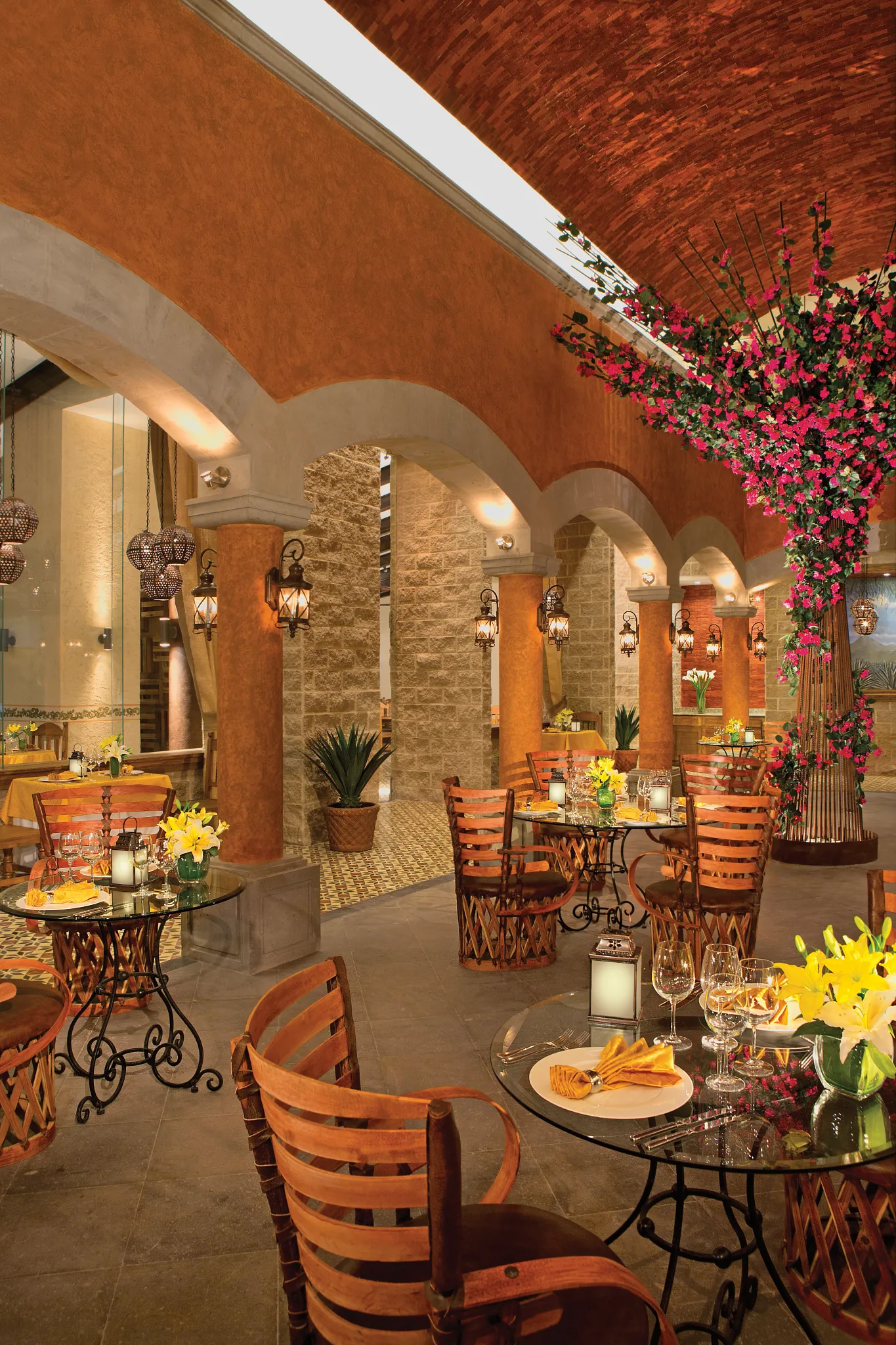 Tamarindo Mexican restaurant at Dreams Vallarta Bay Resort & Spa featuring elegant open-air dining with arches, lantern lighting, and traditional décor.
